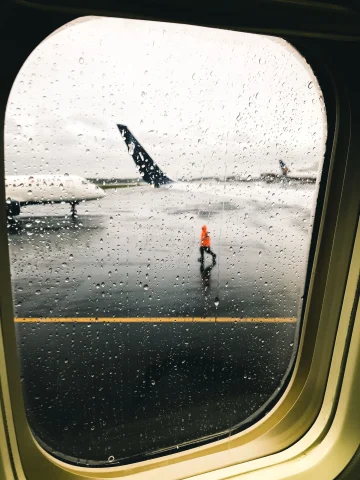 A picture taken from inside an airplane's window of the runway.