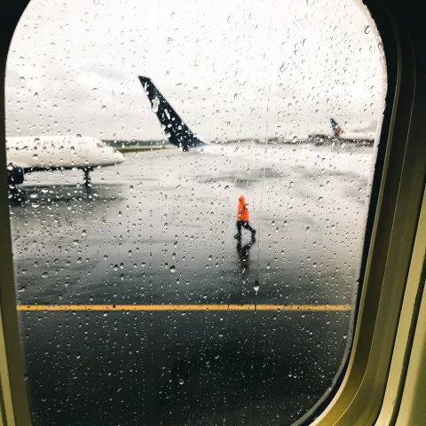 A picture taken from inside an airplane's window of the runway.