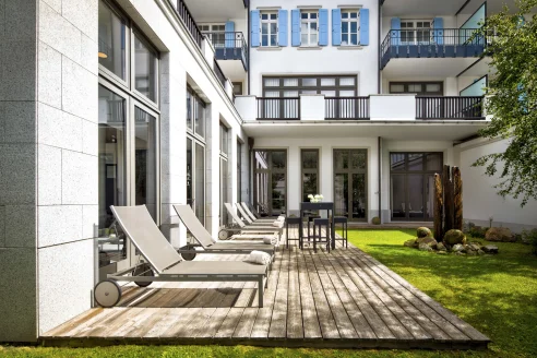 wooden deck with lounge chairs in a courtyard