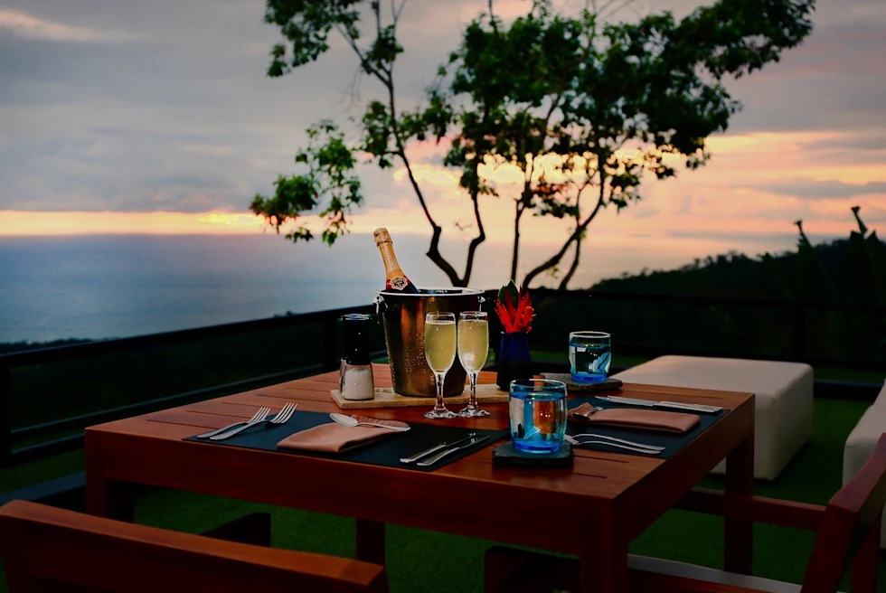 A rooftop dinner table during sunset