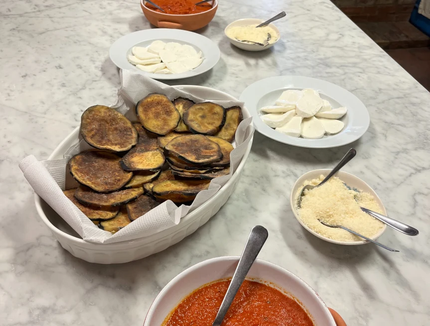 roasted eggplant slices and a red sauce on a marble counter