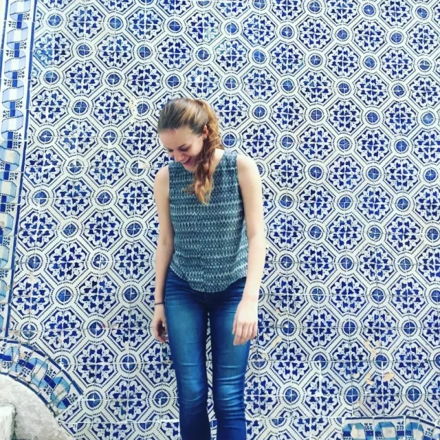 Travel Advisor Alison Eadie in front of blue and white tiles in Portugal.