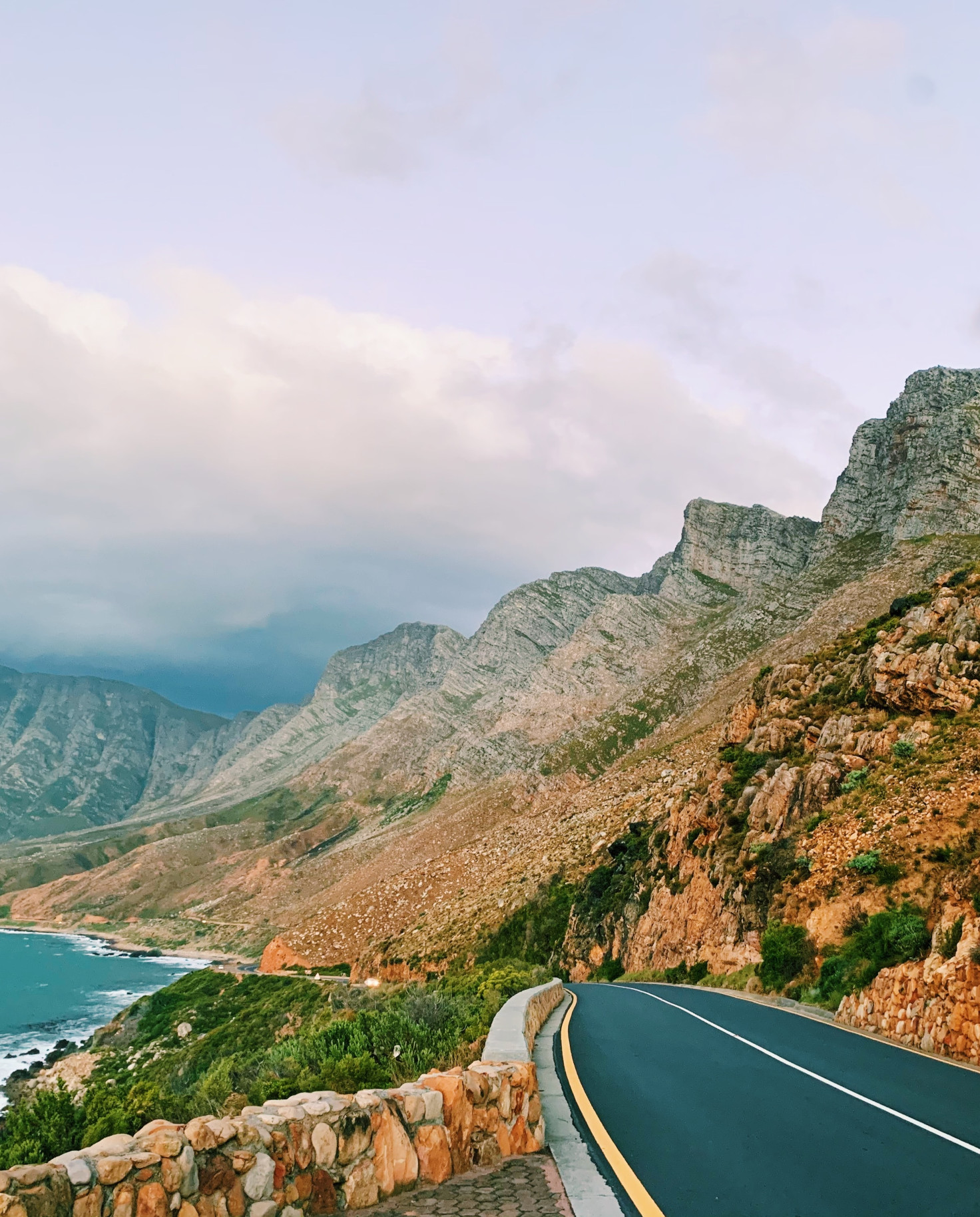 Road running alongside the blue ocean and mountains in South Africa