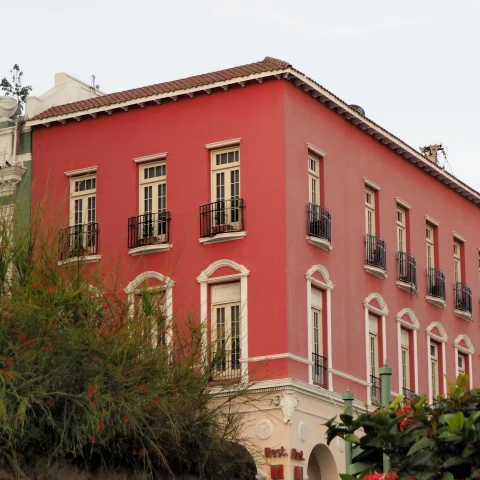 A red house flanked by tropical fauna and flowers in Puerto Rico. 