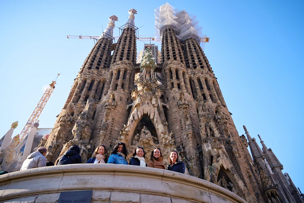 Gaya Vinay and friends standing in front of a Gothic cathedral