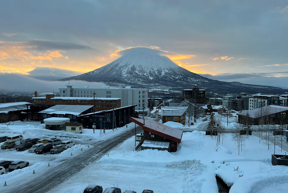 buildings near road with mountain in background