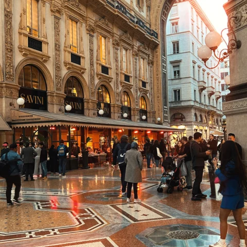 A picture of the interior of a European building with people walking around.