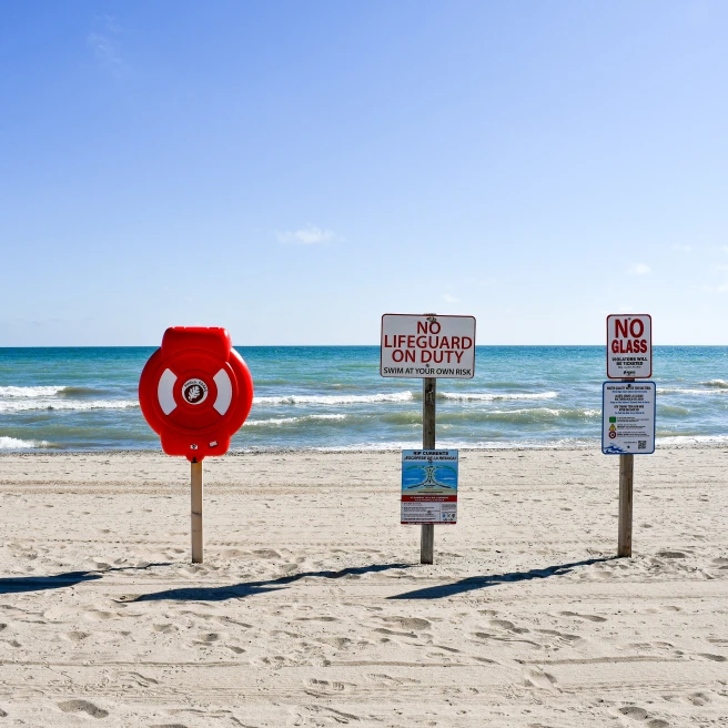 A beach with lifeguard signs. 