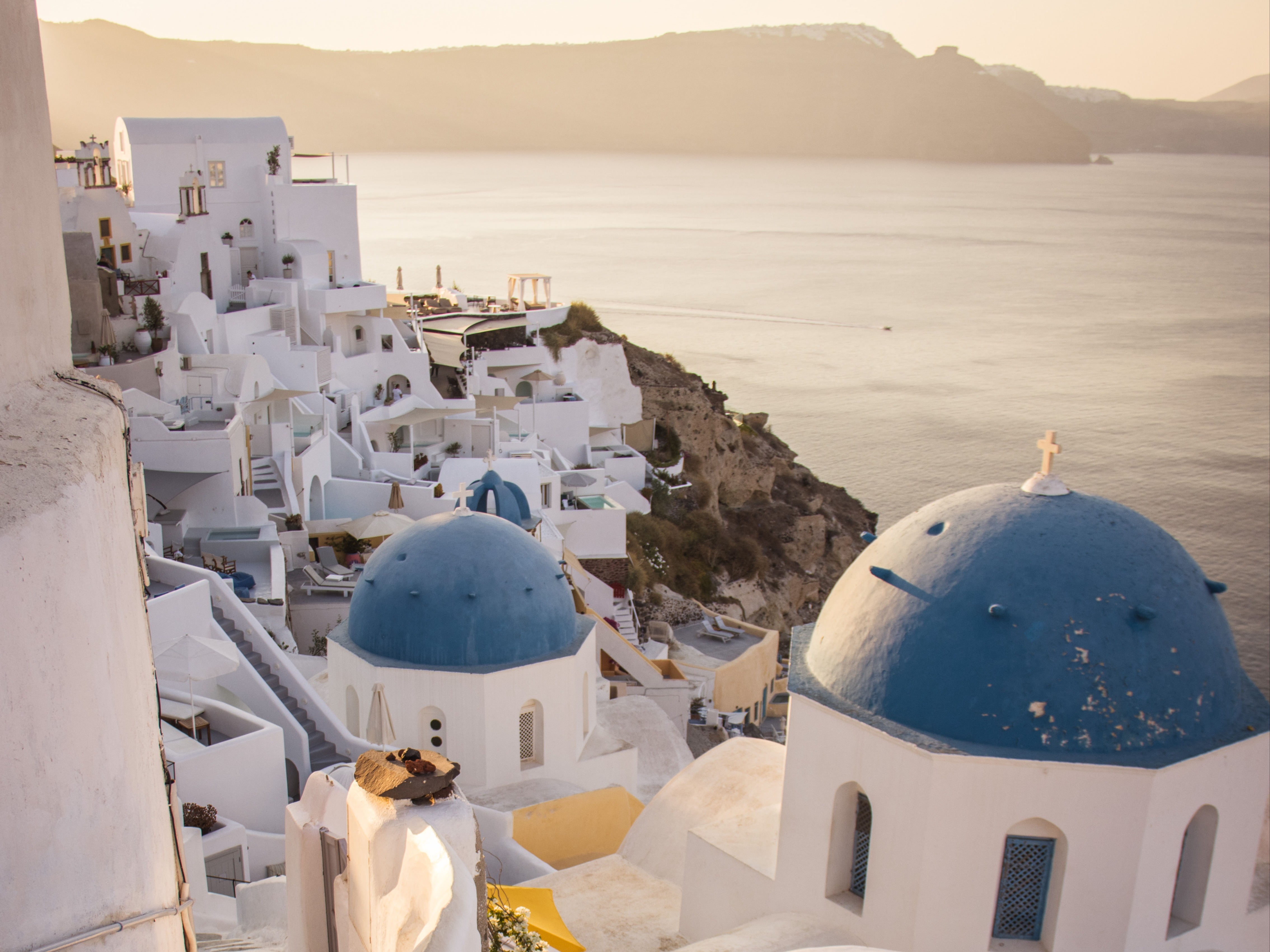 santorini white buildings with sea view in backdrop on a sunny day