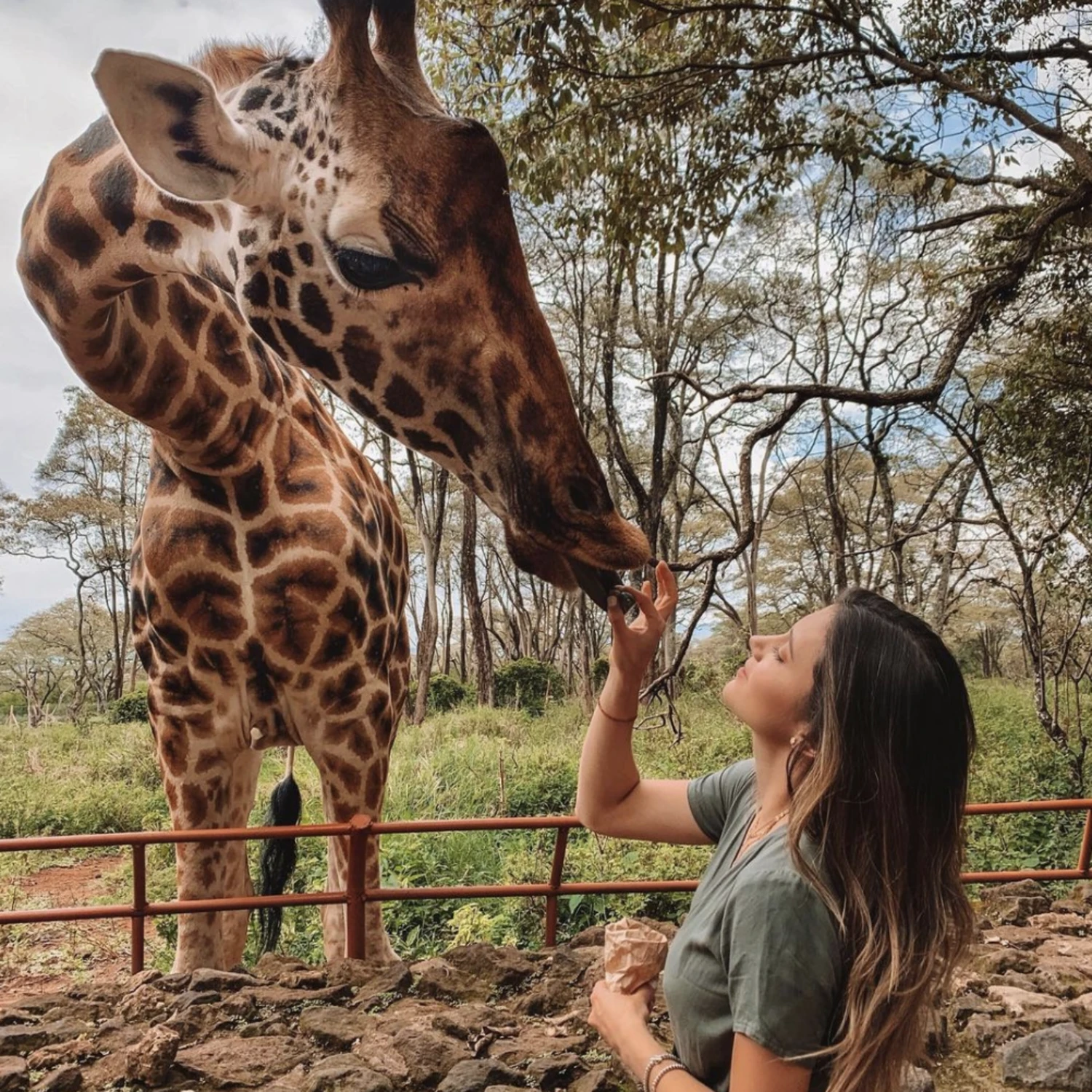 Travel advisor posing with a giraffe