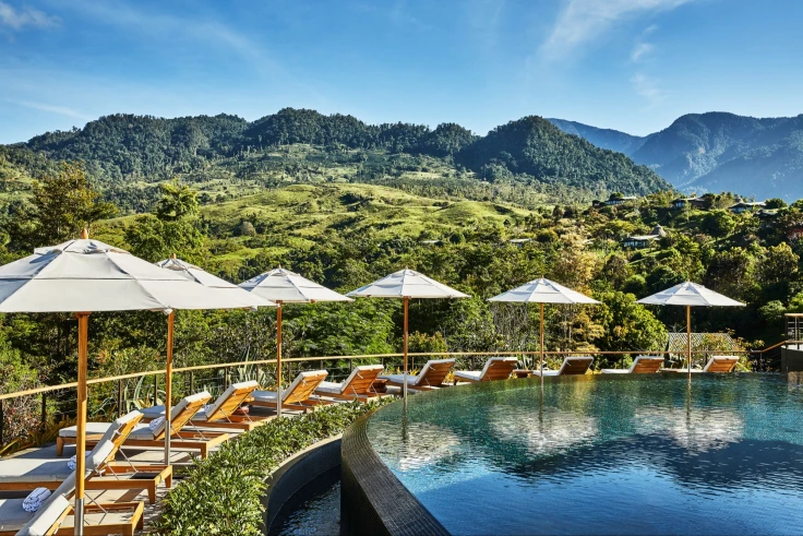 infinity pool overlooking a jungly mountain landscape