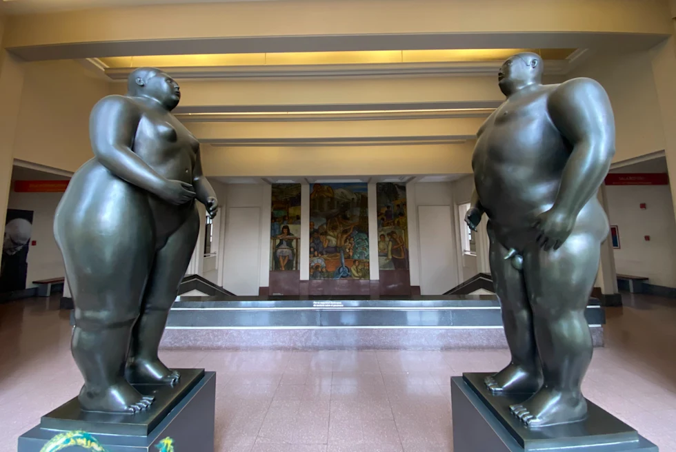 Two big sized naked statues of a man and woman.
