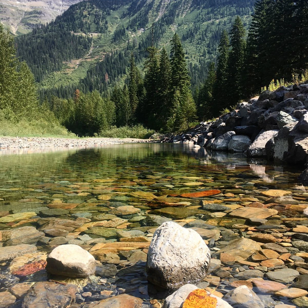 alpine lake in the valley of towering rocky peaks