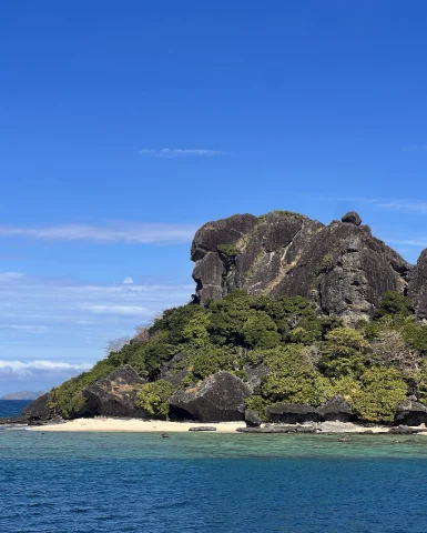 An ocean with a rocky hill on an island. 