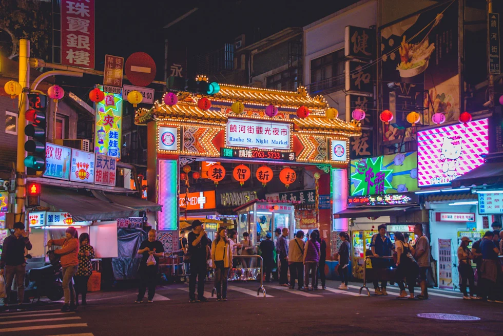 Group of people standing in city during nighttime