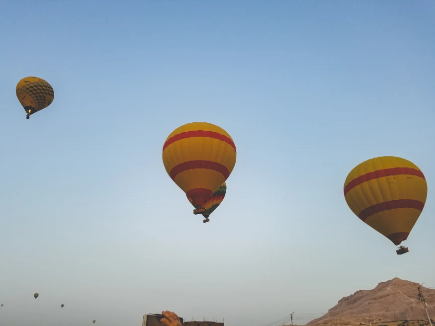 Yellow and red hot air balloons in the sky during daytime
