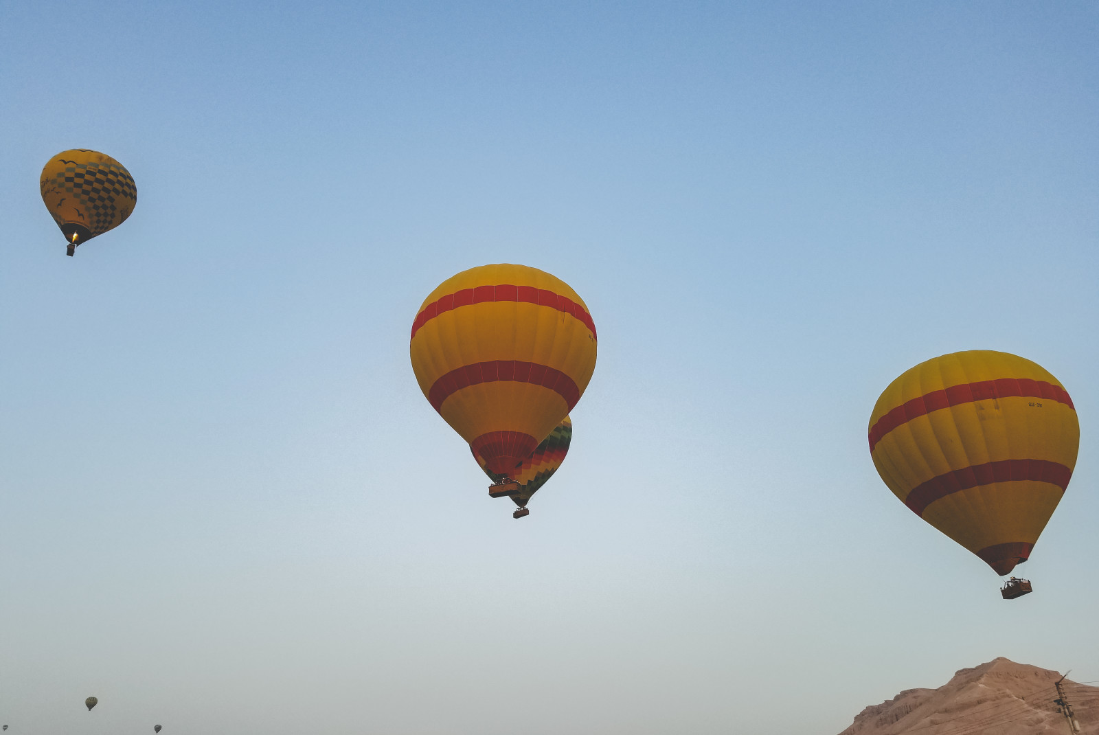 Yellow and red hot air balloons in the sky during daytime