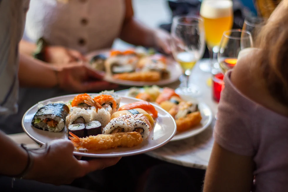 person holding white plate of food