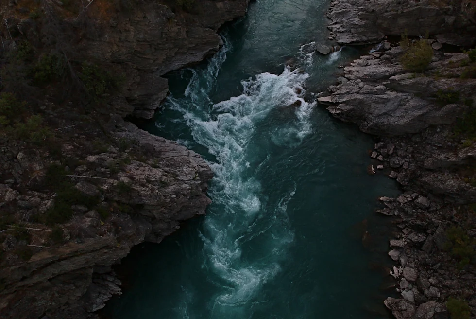 Aerial view of blue river surrounded by rocks in New Zealand