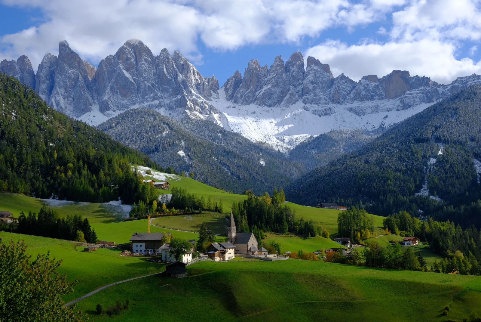 Dolomites mountains and valley with a wooden house. 