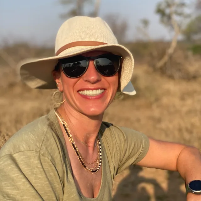 Travel Advisor Lauren Polivka with a green shirt and a tan hat.