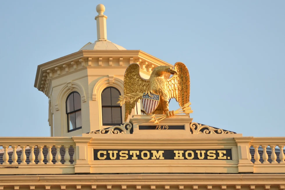 golden eagle statue on top of a cream-colored building