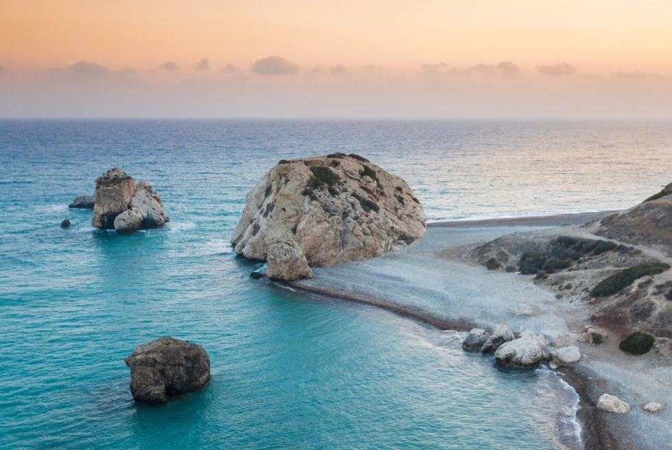 A light blue beach with rocks.