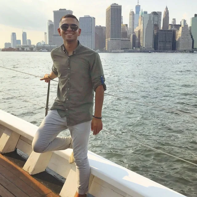 Travel Advisor Jonathan Aciego on a boat cruise on the water off a city