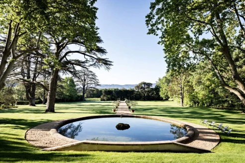 a reflective pool amid a manicured garden