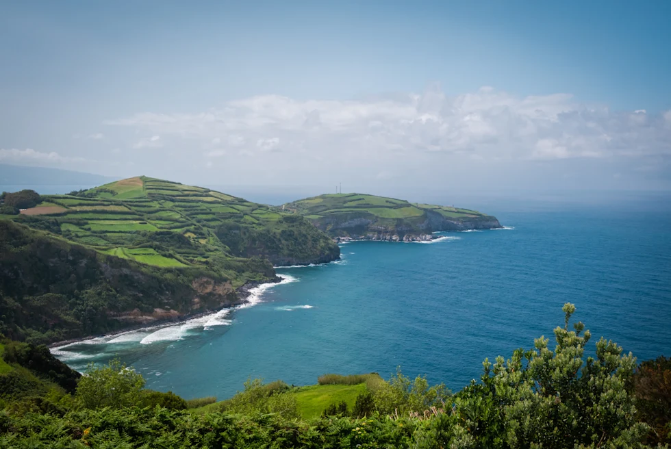Blue sea surrounded by green hills.