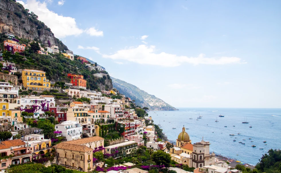 View of colorful buildings along the ocean in Positano, Italy