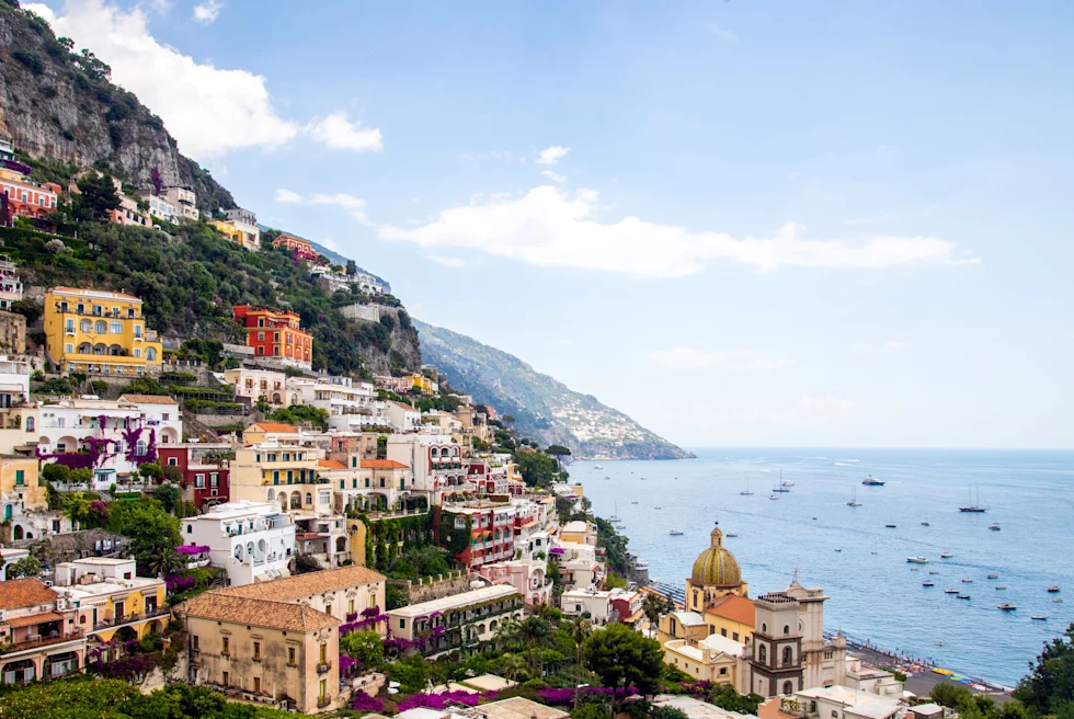 View of colorful buildings along the ocean in Positano, Italy