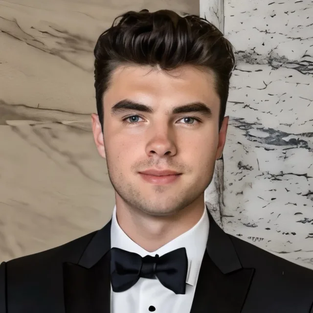 Picture of Landon in black suit in front a marble wall
