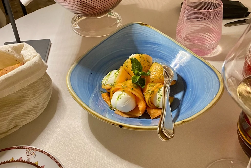 A blue ceramic bowl with white and yellow dish.