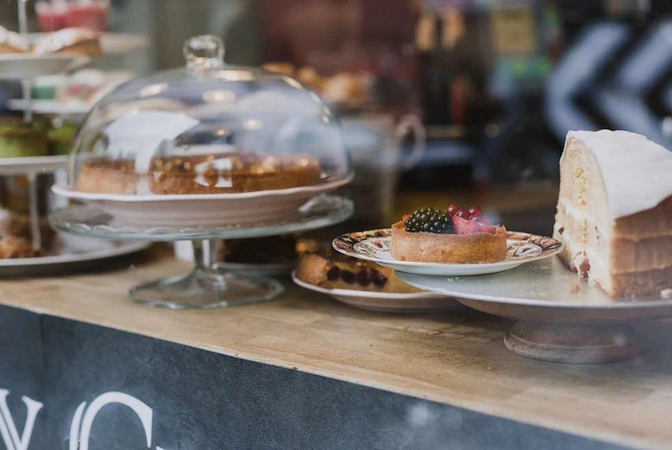 up-close bakery counter with tarts and cake