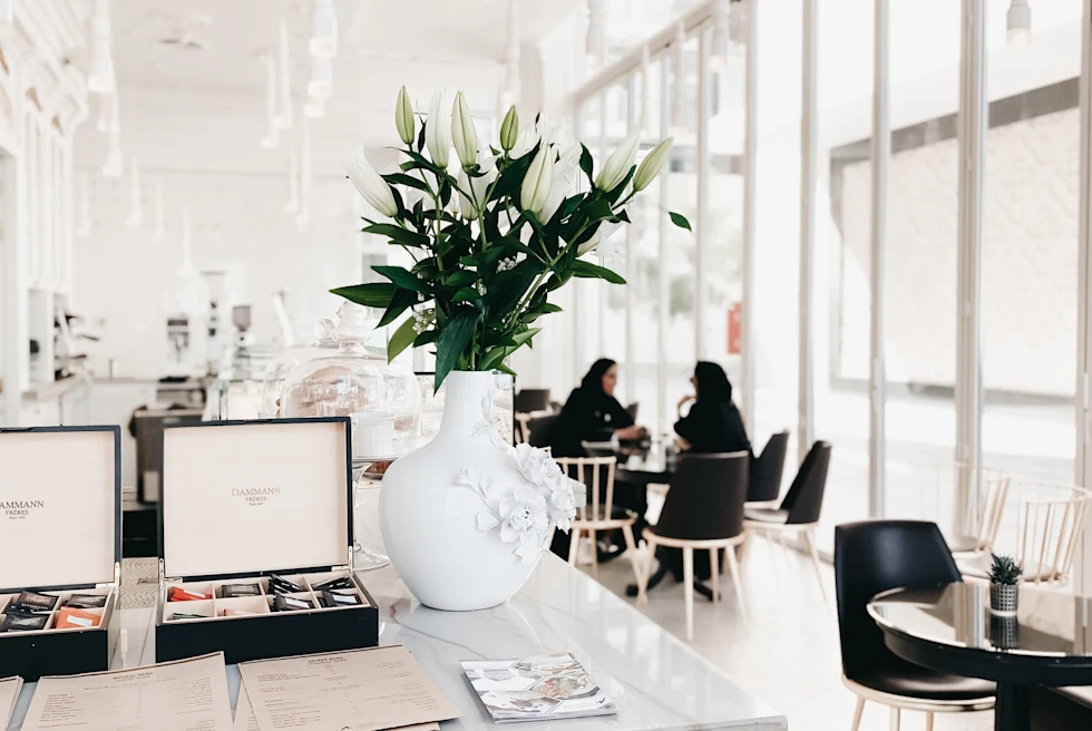 White floors and black chairs in cafe in Dubai