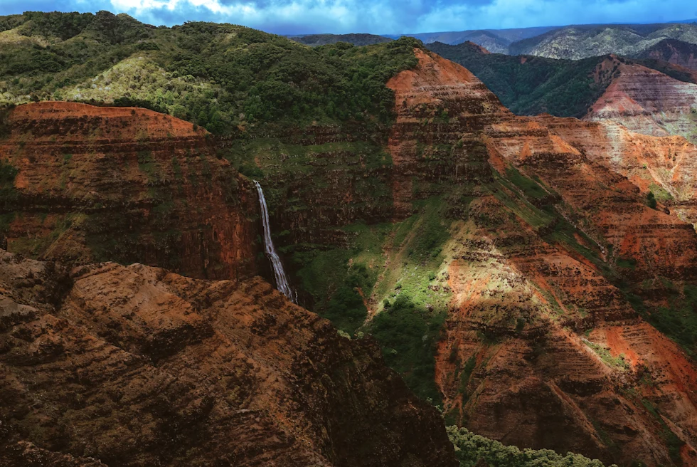 aerial view of large canyon with waterfall