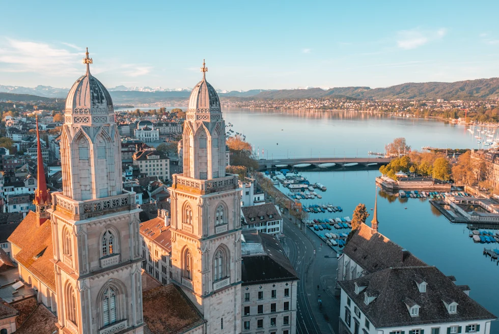 Aerial view of the city with church, buildings and lake.