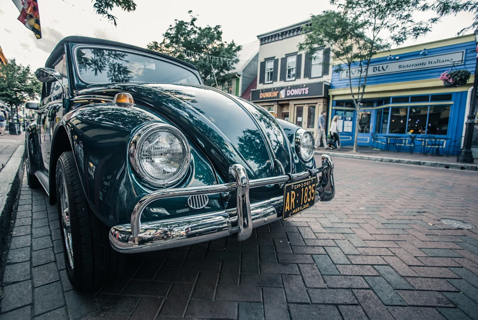 Car on street next to buildings on a cloudy day