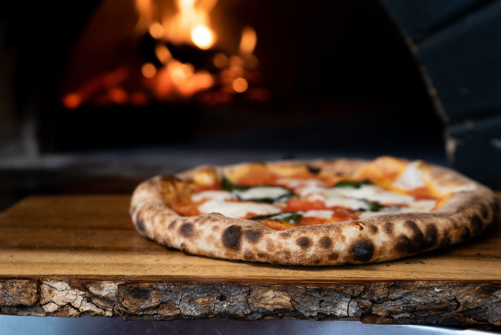 Pizza Napoletana on brown wooden table