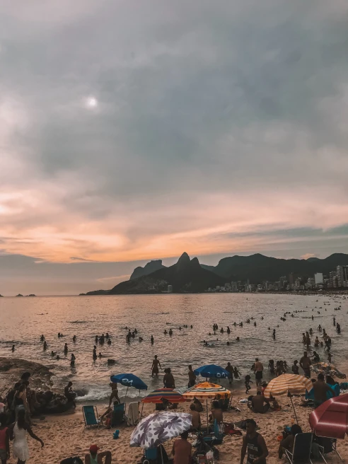 Arpoador beach in Rio de Janeiro filled with people on a cloudy day in Brazil