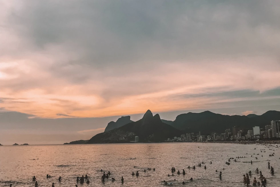 Arpoador beach in Rio de Janeiro filled with people on a cloudy day in Brazil