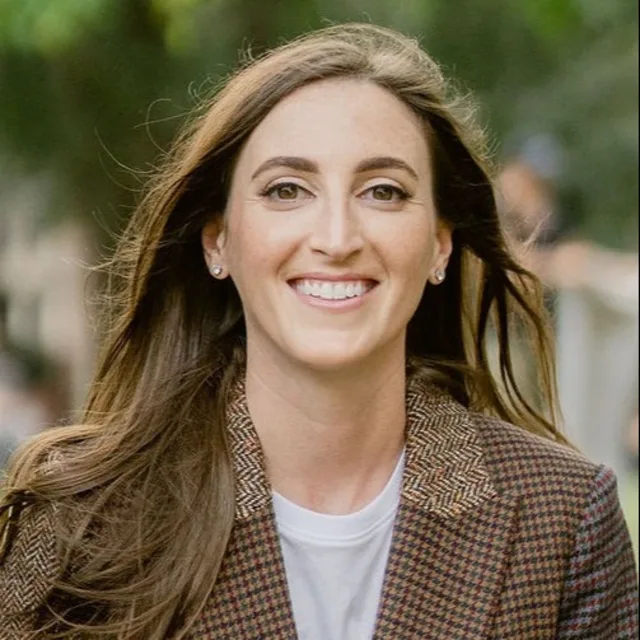 Travel Advisor Taylor Rosen with a white shirt and tweed jacket on.