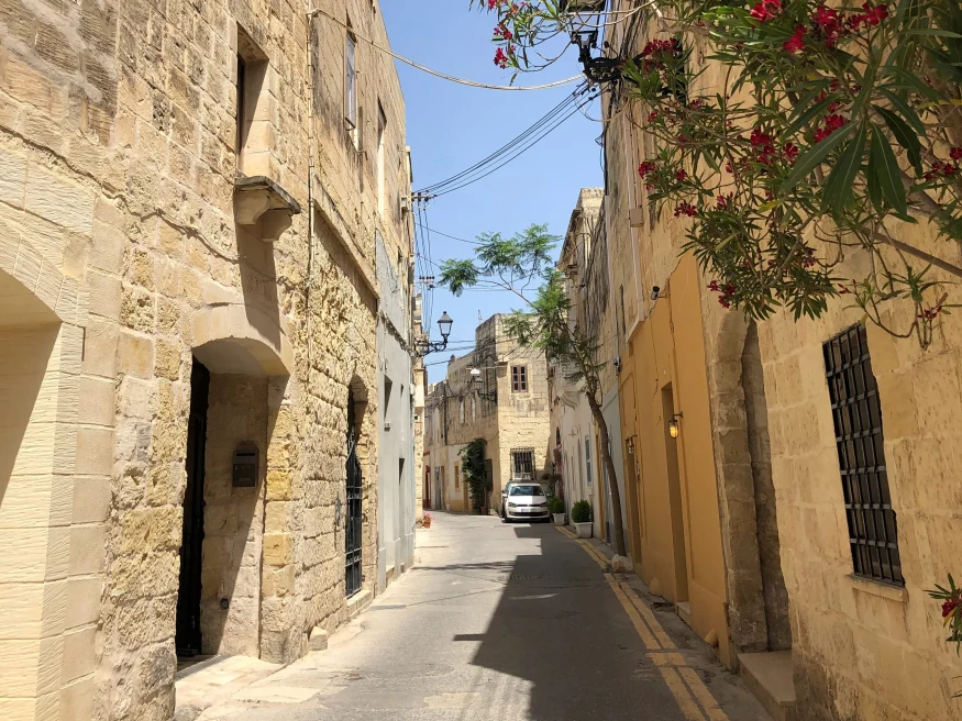 Narrow street with a parked car during daytime