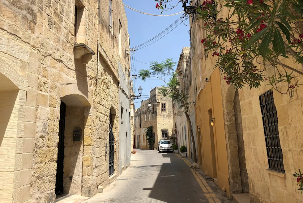 Narrow street with a parked car during daytime