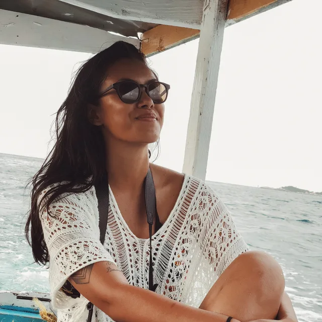 Travel advisor Amanda Villarosa smiles on a boat while at sea.