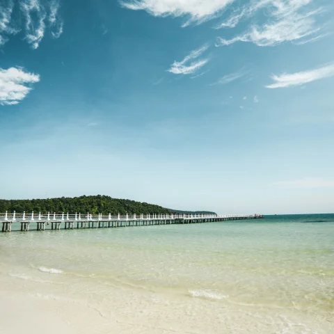 Transparent blue beach and a pier in Koh Rong. 