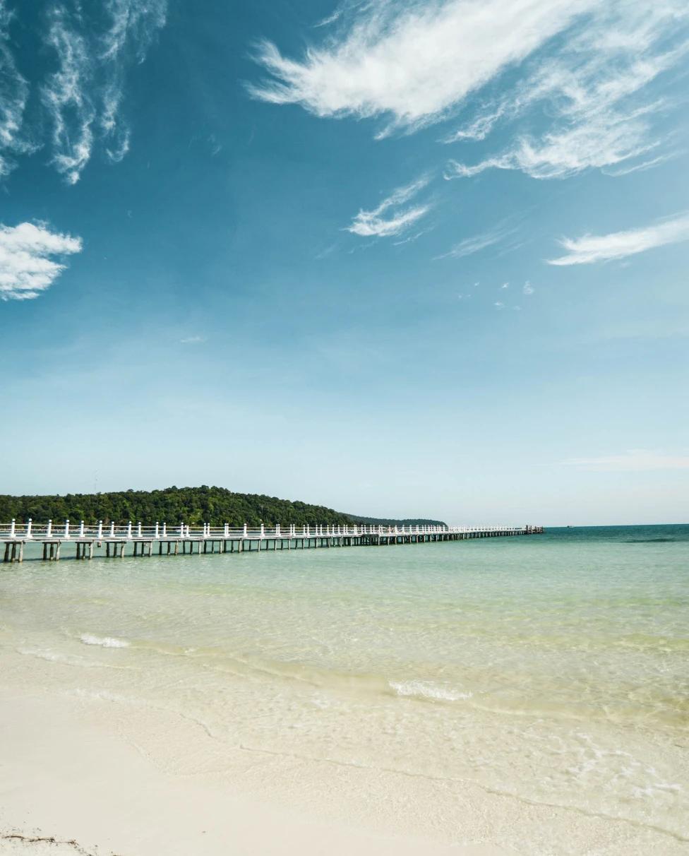 Transparent blue beach and a pier in Koh Rong. 