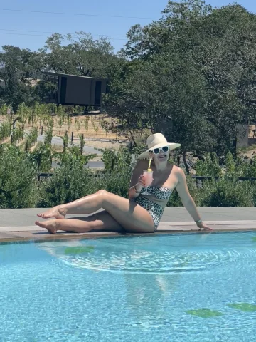 Travel advisor posing by a pool