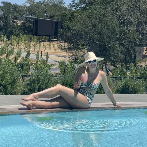 Travel advisor posing by a pool